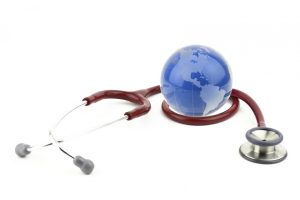 Photo of a small globe sitting by a stethoscope