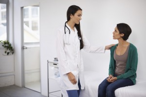 A doctor comforting a patient who has received bad news