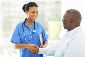 A nurse shakes a patient's hand