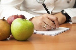 Doctor writing on prescription pad