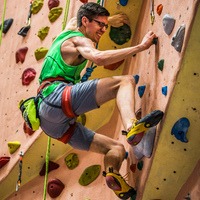 Janson climbing a rock wall