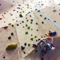 Yonge climbing a rock wall