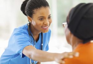 nurse with her hand on her patient's shoulder