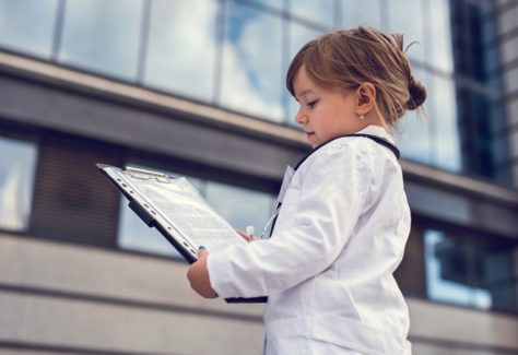 little girl in medical lab coat