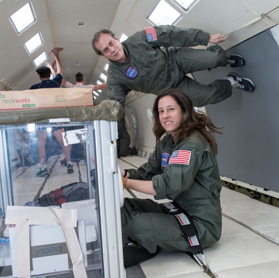 Lindsay Rizzardi and Andy Feinberg practice pipetting at zero gravity on the "Vomit Comet."