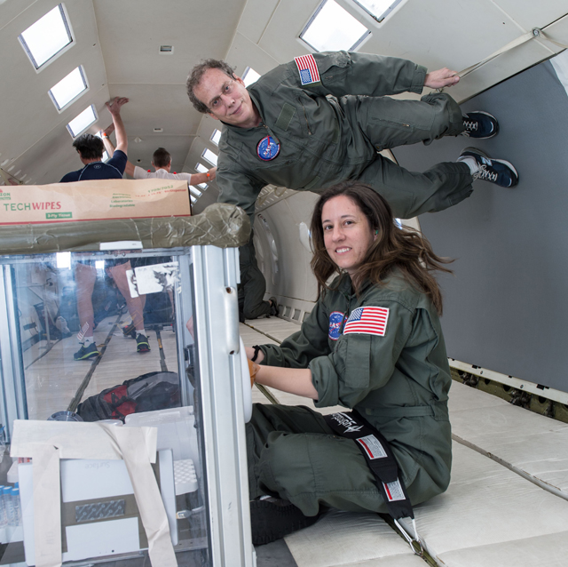 Lindsay Rizzardi and Andy Feinberg practice pipetting at zero gravity on the "Vomit Comet."