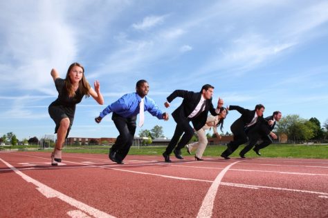 business people running on a track