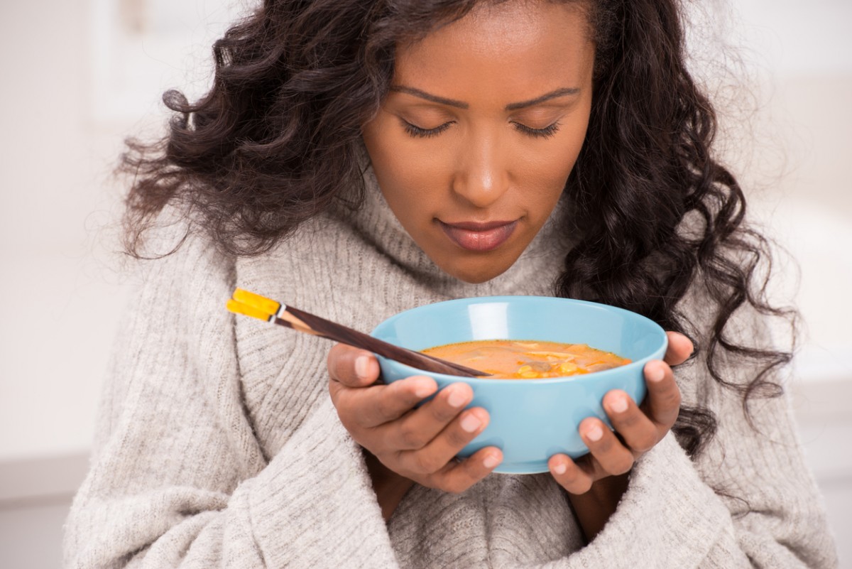 Millennial woman smelling her food