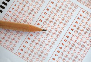 A pencil rests atop a standardized testing sheet.