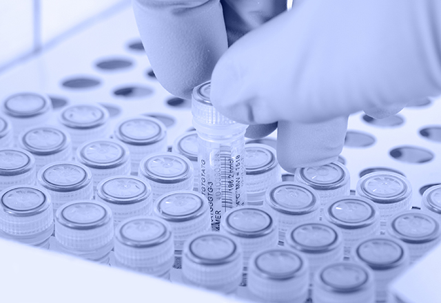 Scientist removes a test tube. Gloved hand. Light blue tint applied to image.