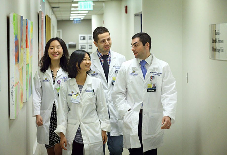 A group of Dermatology residents walk down the hall together.