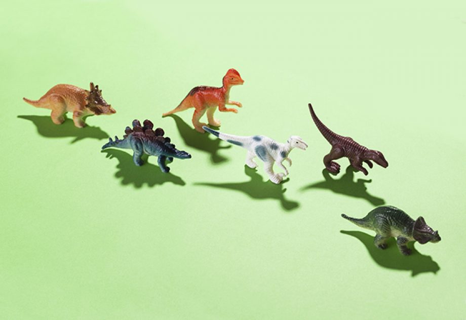 Dinosaur toys on green background