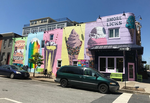 Colorful murals of ice cream cones on the side of a building.
