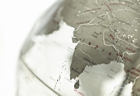 A close-up on India on a plexiglass globe.