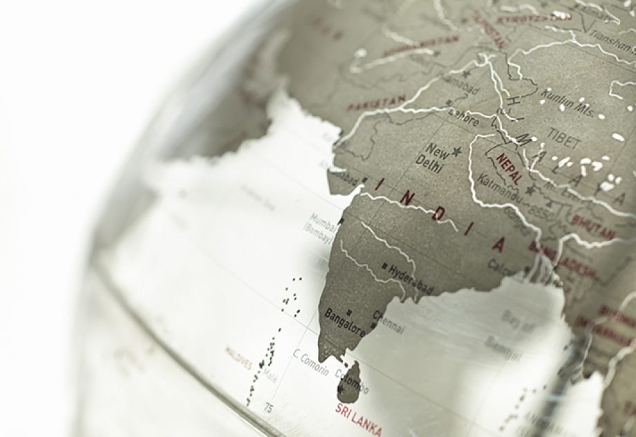 A close-up on India on a plexiglass globe.