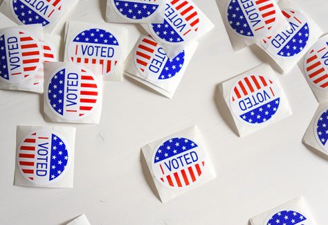 A collection of "I Voted" stickers scattered across a table.
