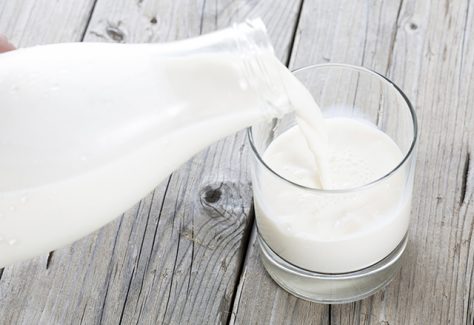 Milk is poured from a bottle into a glass.