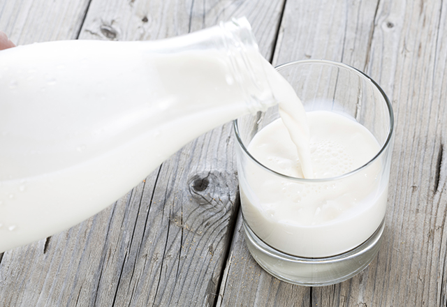 Milk is poured from a bottle into a glass.