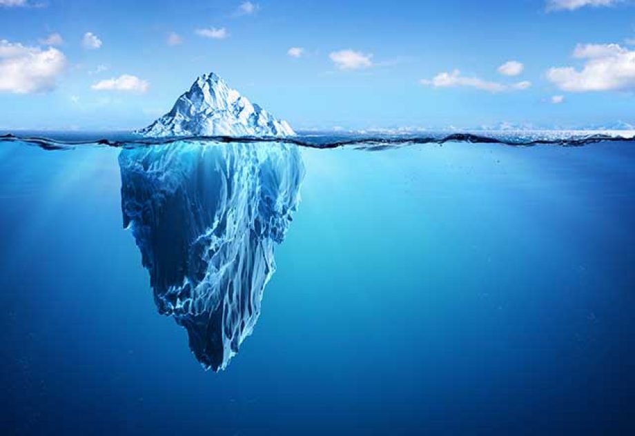 Image showing the tip of an iceberg above the water.
