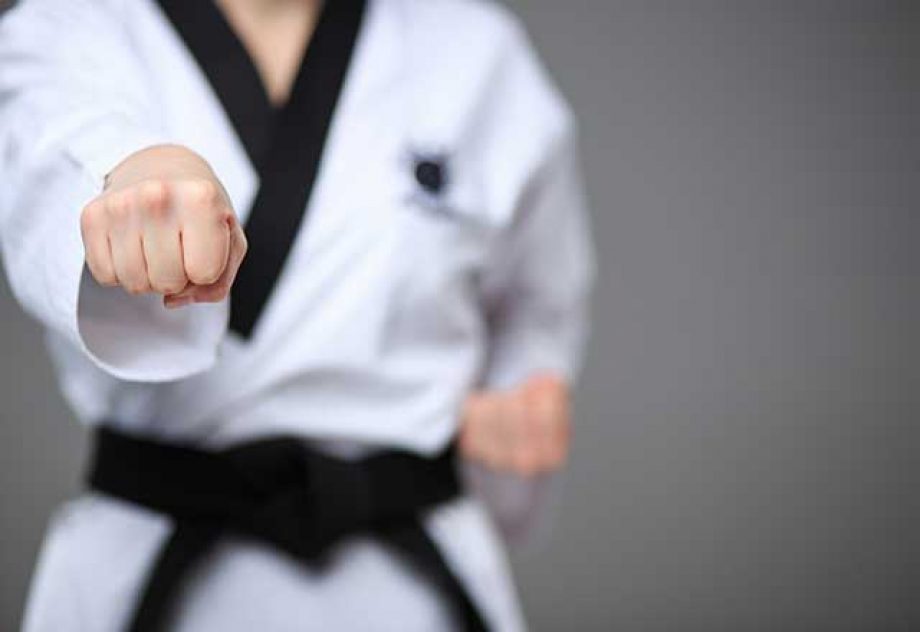 Person punching forward while practicing taekwondo
