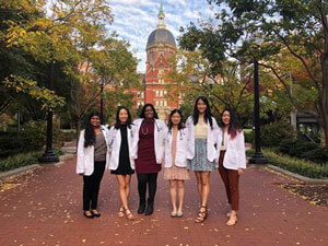 Celebrating our new white coats and stethoscopes in front of the dome.