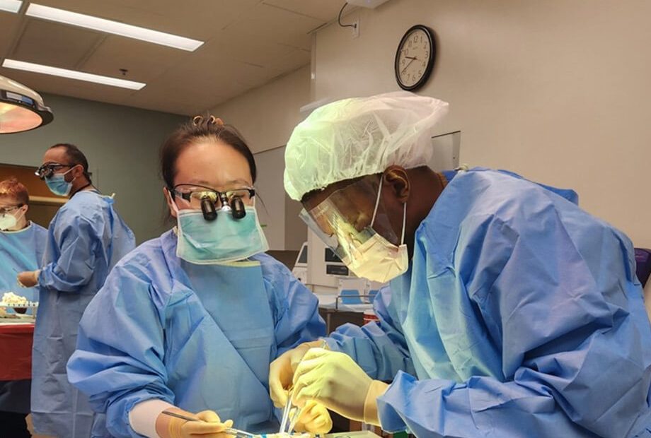 Two medical students work in a surgery lab.