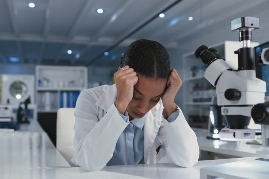 Shot of a young scientist looking stressed while conducting medical research in a laboratory