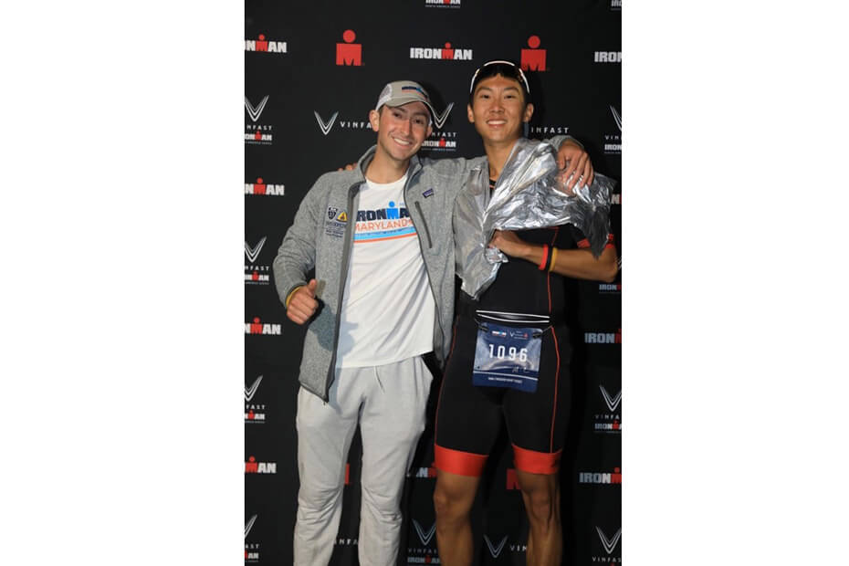 Second-year medical students Luke Tomasovic, left, and Thomas Su at the finish line of the 2023 IRONMAN Maryland.