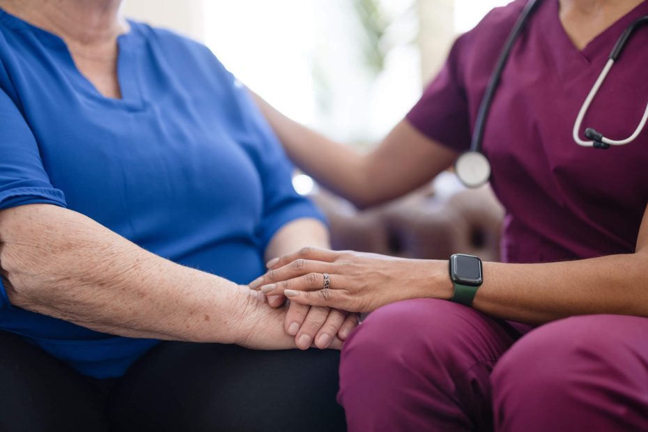 A nurse visiting a senior patient at home.