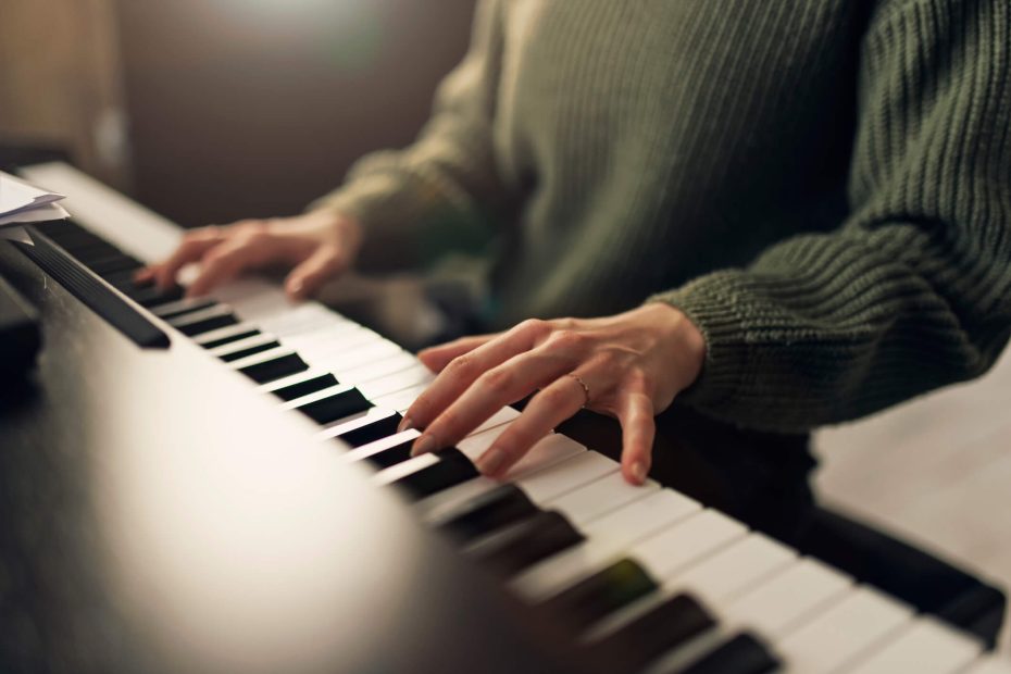 Teenage girl is practicing playing the piano in the living room.