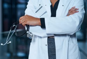Closeup shot of an unrecognizable doctor standing in a hospital at night
