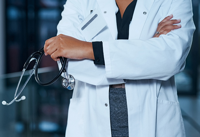 Closeup shot of an unrecognizable doctor standing in a hospital at night