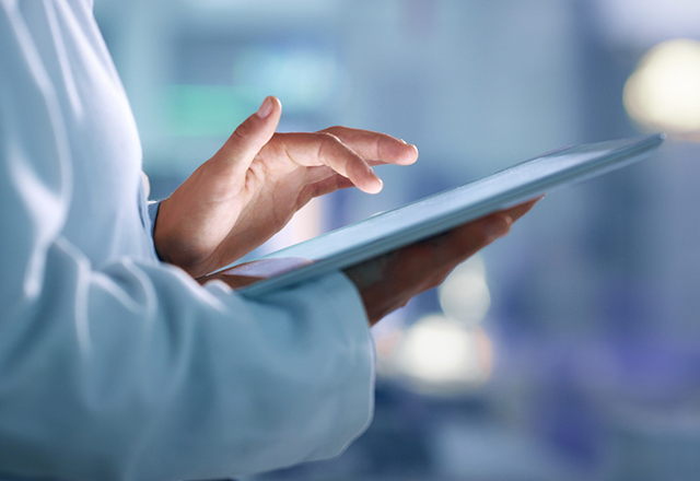 Doctor, researcher or scientist browsing the internet on a tablet for information while working at a lab, science facility or hospital. Expert, medical professional or surgeon searching the internet