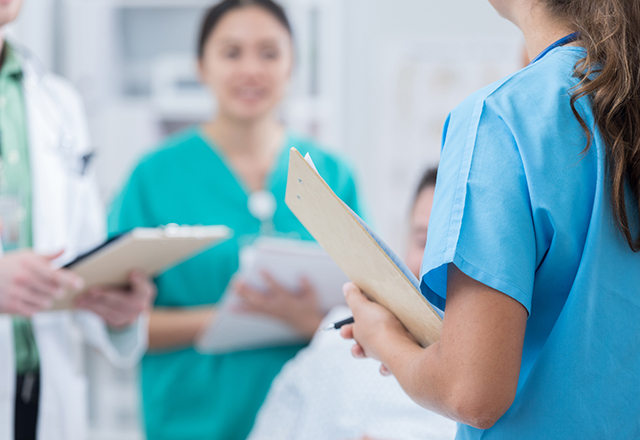 Medical students go on rounds with experienced doctors. They are checking the health of a male patient.