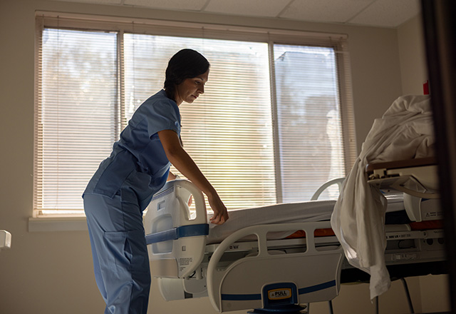 A nurse preparing the hospital room